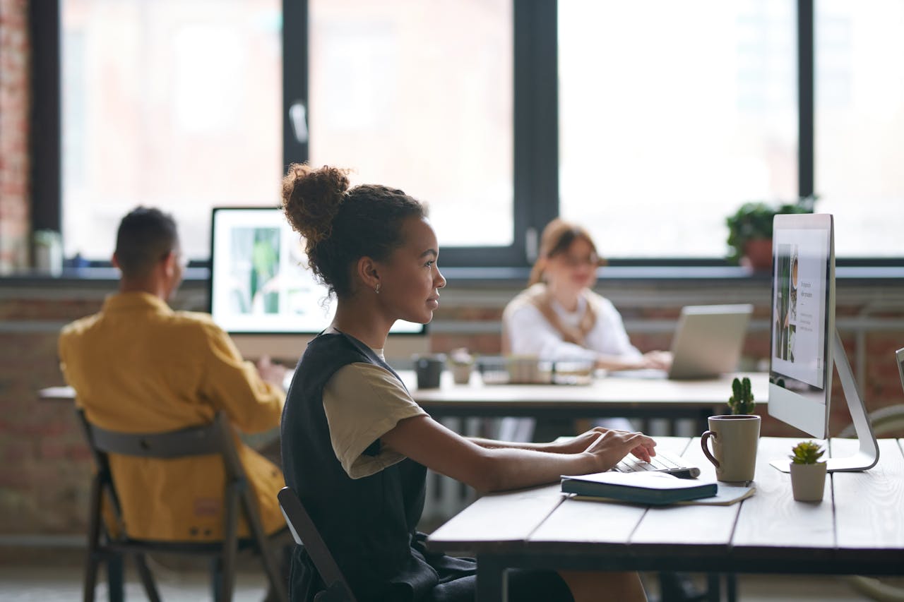 Team working in a bright, stylish office with technology and collaboration focus.